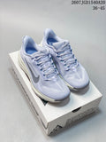 Pair of light lavender Nike ACG Pegasus Trail sneakers displayed on a shoe box, showing the woven-looking upper, laces, gray Swoosh, and cushioned midsoles.