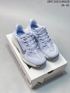 Pair of light lavender Nike ACG Pegasus Trail sneakers displayed on a shoe box, showing the woven-looking upper, laces, gray Swoosh, and cushioned midsoles.