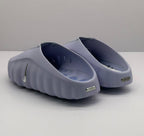 Rear view of the purple slides showing the open heel design and heel branding plaques.