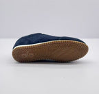 Underside view of the sneaker showing the gum-colored outsole and patterned tread.