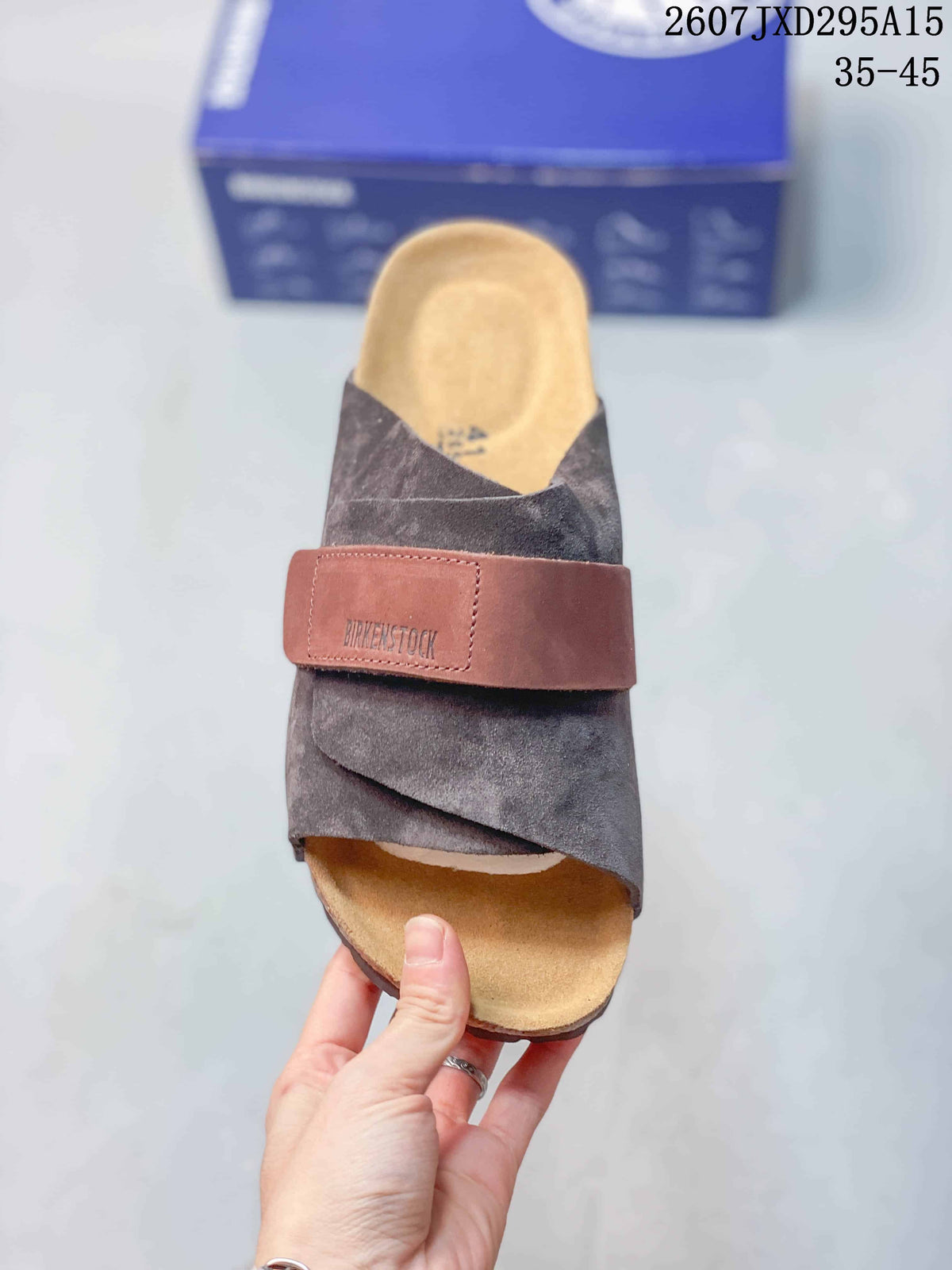 Top view of one clog showing the closed toe, dark gray upper, brown strap, and tan footbed.