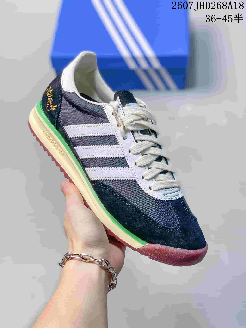 Angled side view showing the navy and white upper, Bob Marley-themed heel embroidery, green midsole accent, and burgundy outsole.