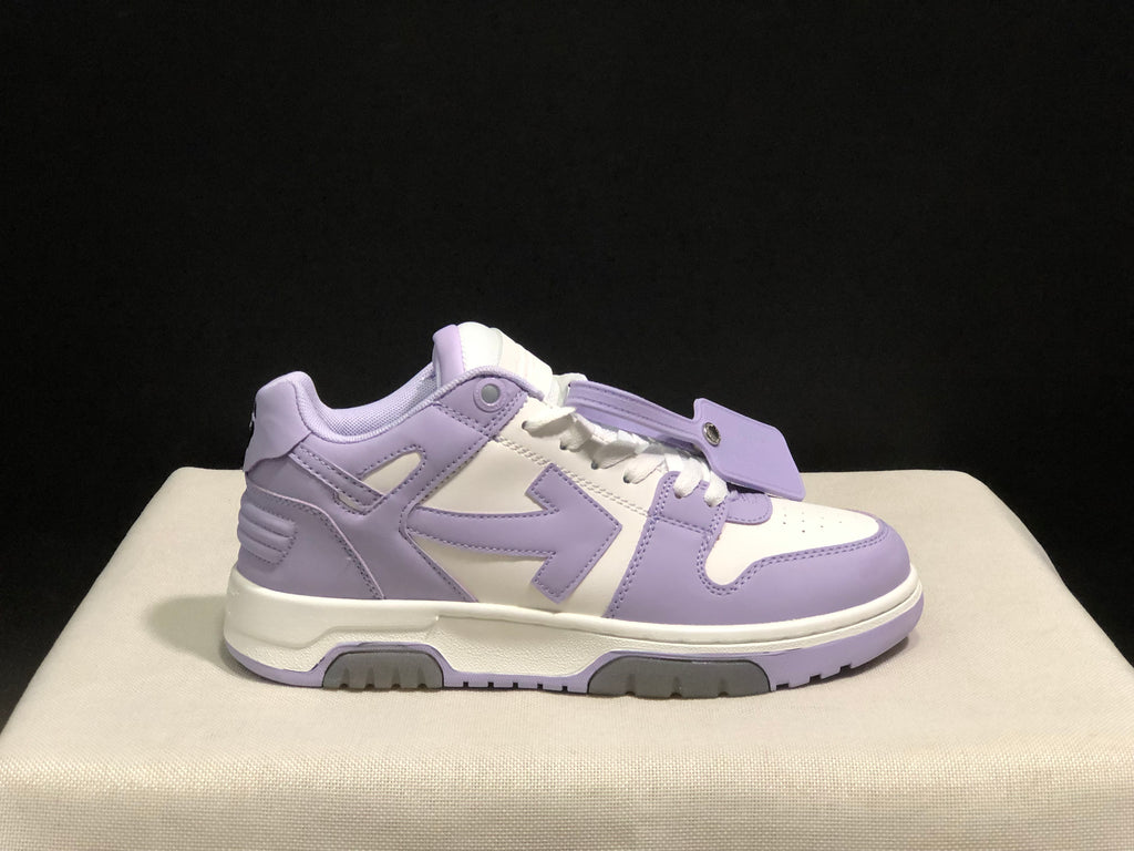 Detailed lateral view of one lavender and white sneaker with its attached lace tag.
