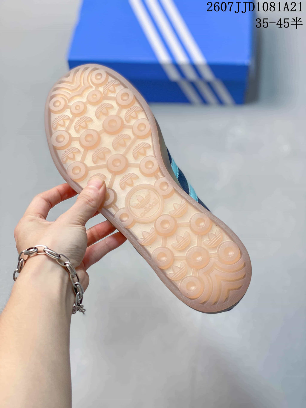 Close view of the translucent gum-colored outsole showing its circular and Trefoil-patterned tread.