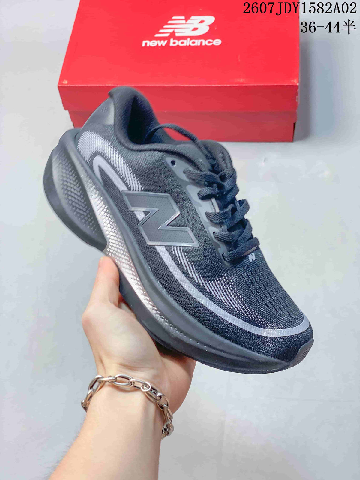 Dark charcoal New Balance running shoe with gray detailing and a dark sole.