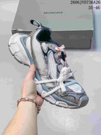 White Balenciaga 3XL-style sneaker with silver and dark accents