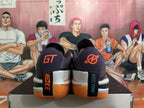 Rear view of purple Nike GT Cut 3 basketball shoes with orange accents and gum-colored outsoles.