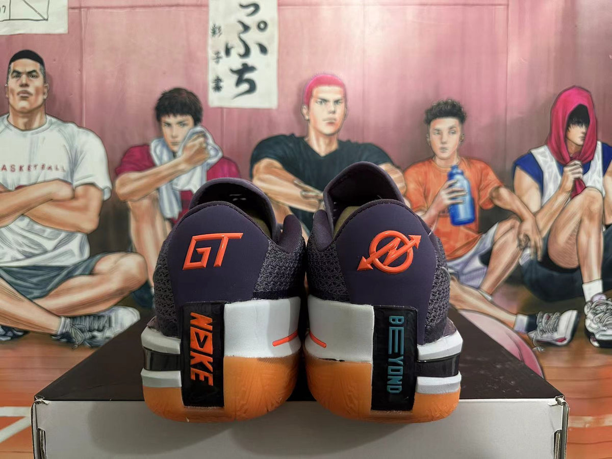 Rear view of purple Nike GT Cut 3 basketball shoes with orange accents and gum-colored outsoles.