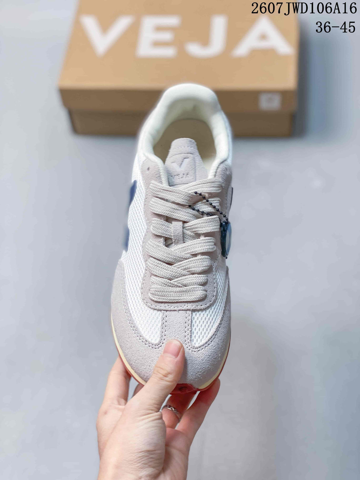 Top view of the sneaker showing the lace-up construction, light upper, blue tongue detail, and contrasting toe overlay.