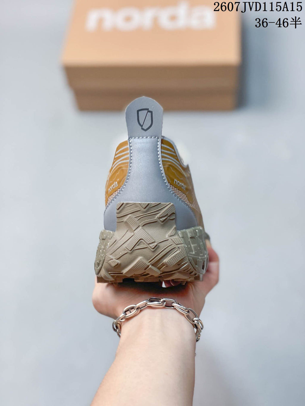 Rear view of the sneaker showing the gray heel panel, pull tab, collar, and textured outsole.