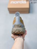 Rear view of the sneaker showing the gray heel panel, pull tab, collar, and textured outsole.