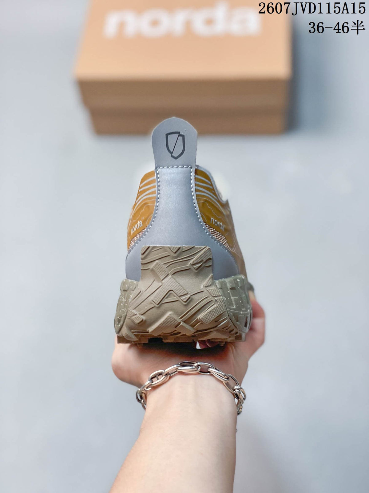 Rear view of the sneaker showing the gray heel panel, pull tab, collar, and textured outsole.