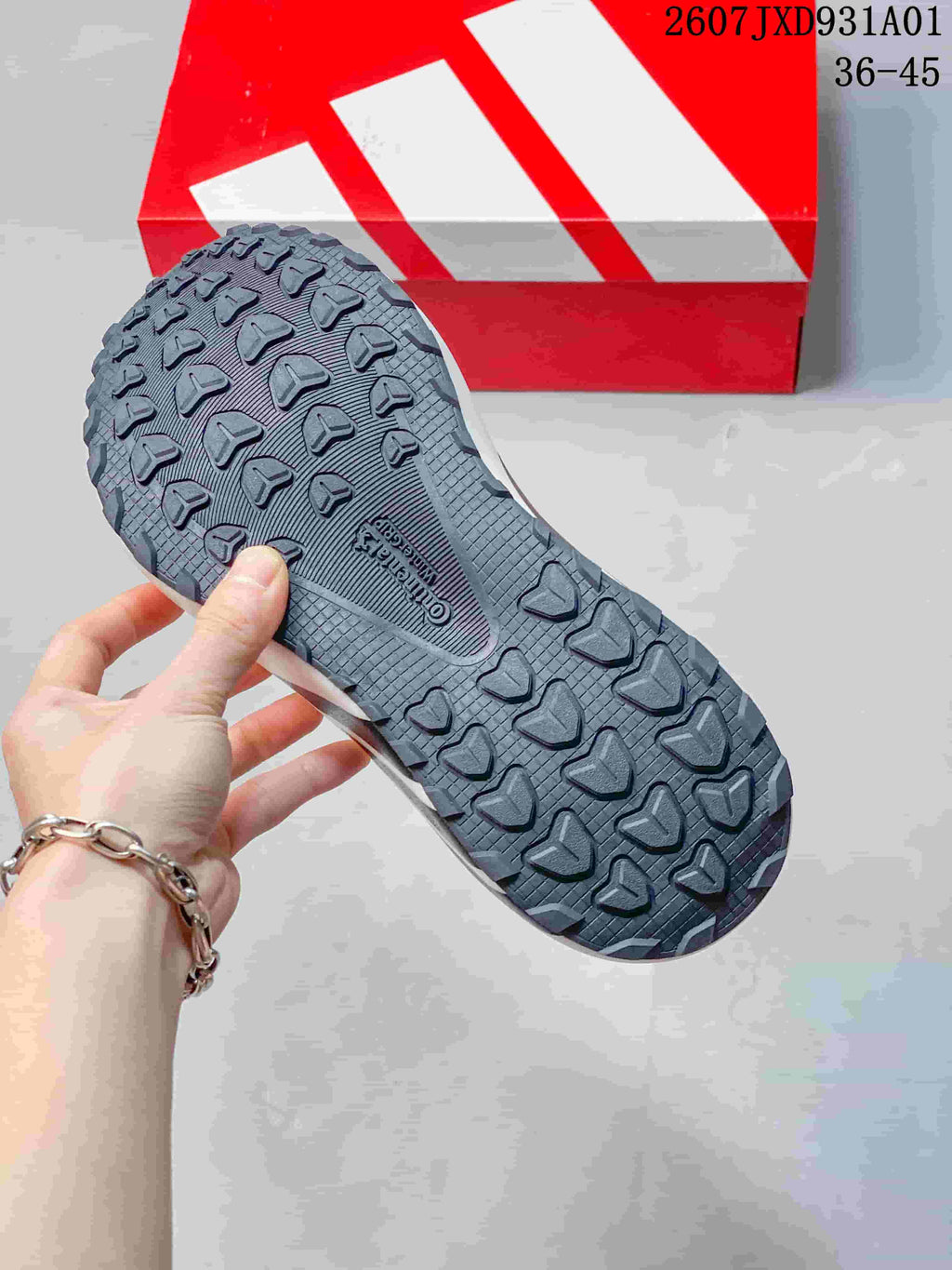 Close-up of the dark patterned outsole on an adidas Hyperboost ATR sneaker