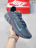 Angled side view of the charcoal gray shoe with blue accents