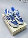 Pair of white and blue Nike low-top sneakers displayed on a shoe box.
