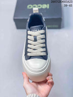 Top view showing the rounded white toe panel, navy upper, and cream laces.