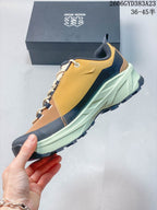 Side view of the low-top hiking shoe with a protective toe bumper and sculpted pale green midsole.