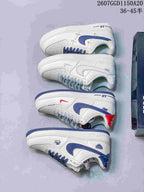Several white Nike low-top sneakers arranged to show side profiles and different blue, gray, and red accent treatments.
