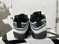 Rear view of white and black Jordan sneakers with camouflage-patterned panels and gold heel embroidery