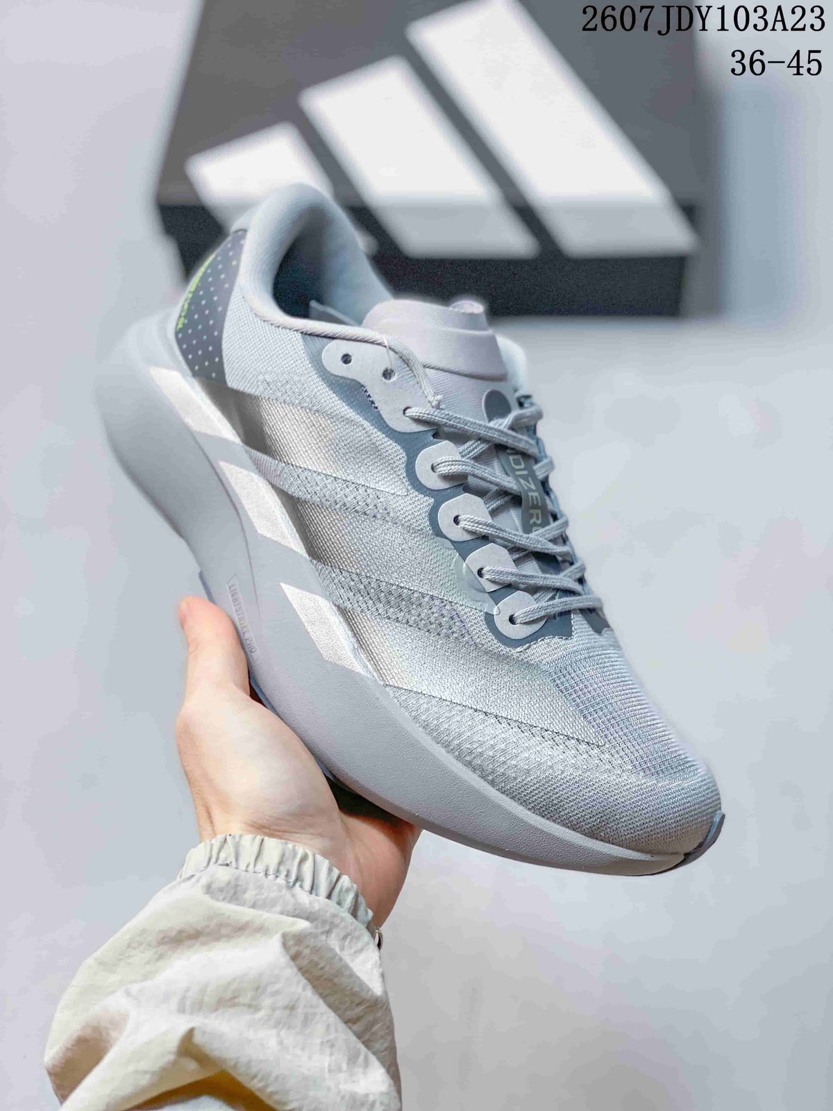 Angled side view of the light gray and white adidas Adizero Evo SL M running shoe with its lace-up upper and raised midsole.