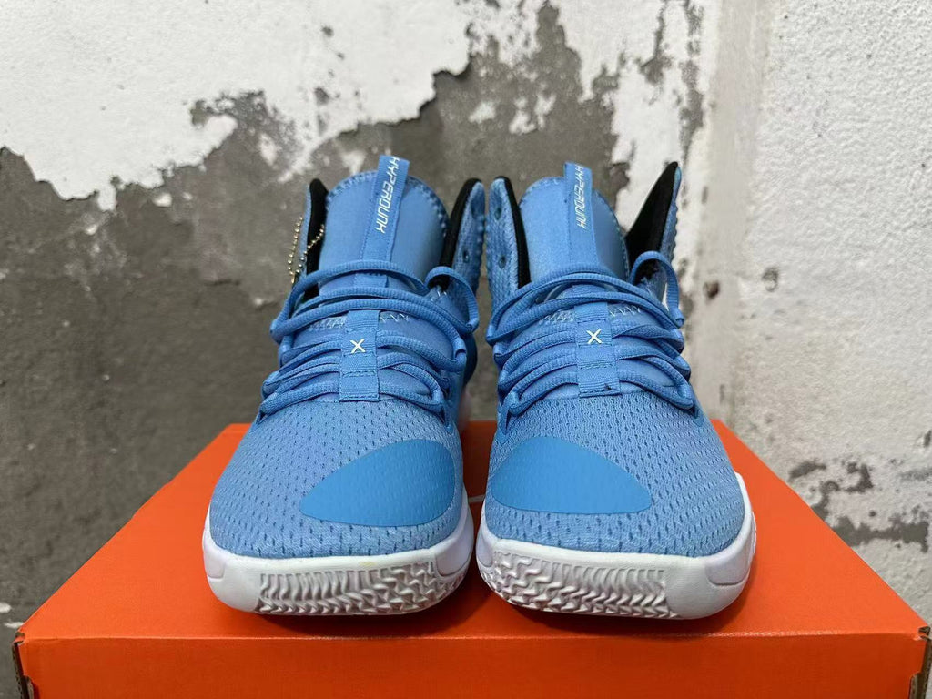 Front view of blue high-top basketball shoes with blue laces and white outsoles.