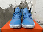 Front view of blue high-top basketball shoes with blue laces and white outsoles.