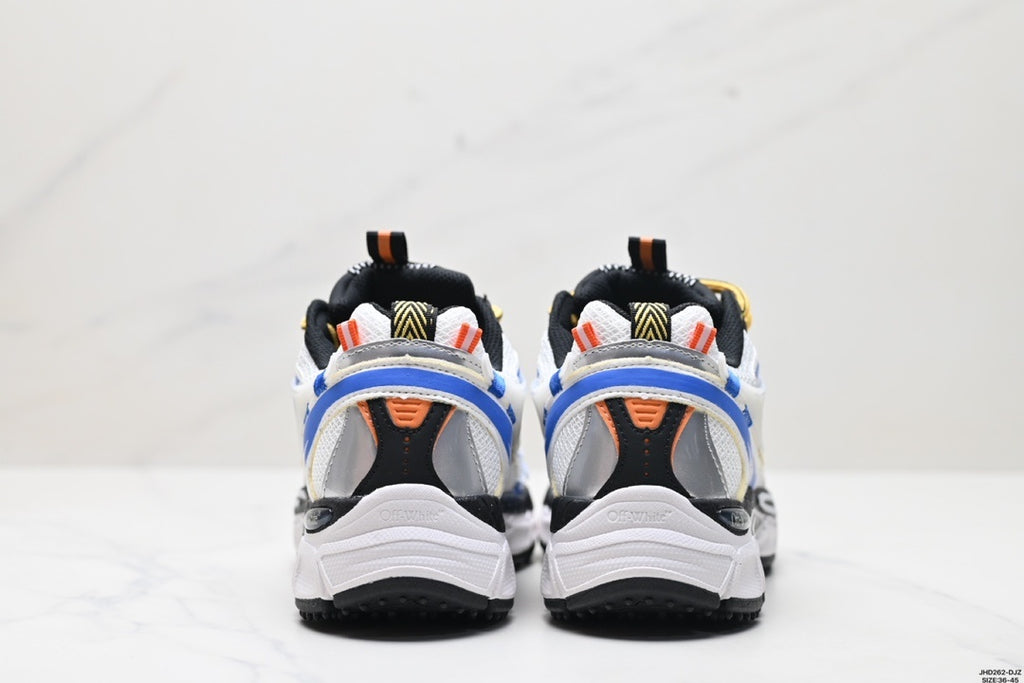 Rear view of the white, blue, black, and yellow sneakers showing layered heel panels and textured black outsoles.