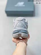 Rear view of the grey sneaker showing the padded heel, New Balance branding, and layered outsole.