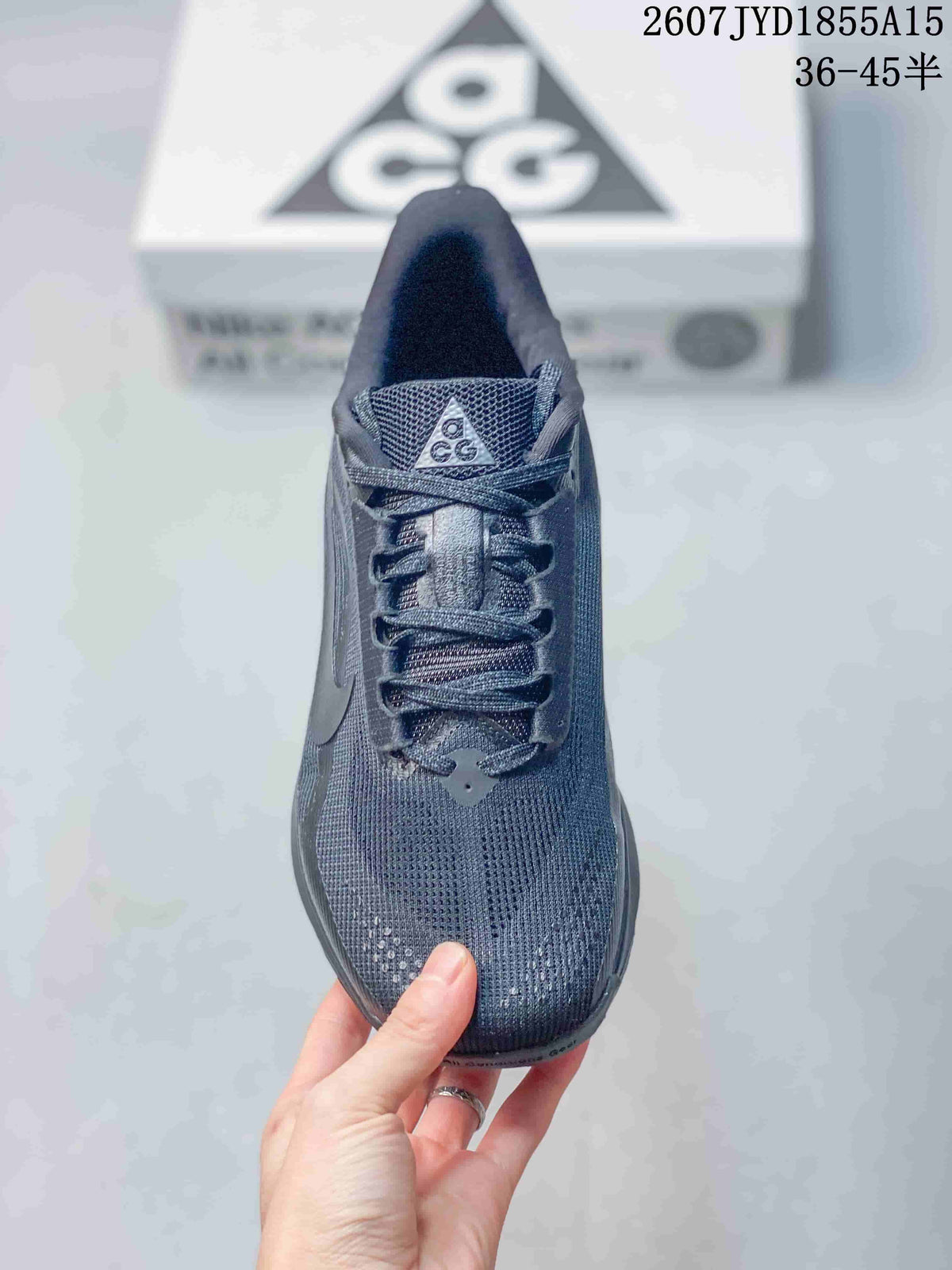 Top view of a dark gray Nike ACG Pegasus Trail sneaker showing the mesh-like tongue, laces, and perforated toe area.