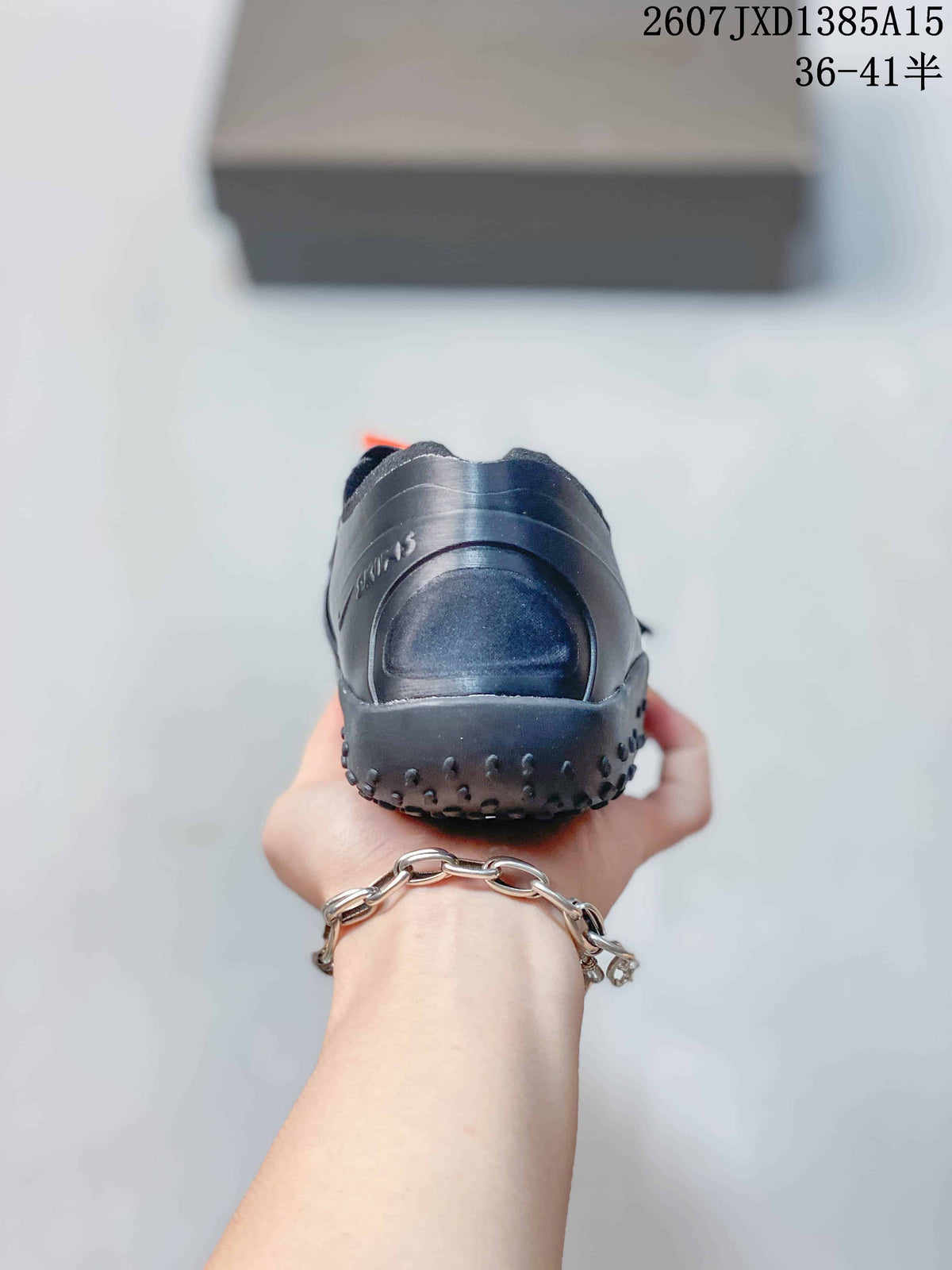 Rear view of a black Nike Air Rift shoe showing the rounded heel and textured outsole edge.