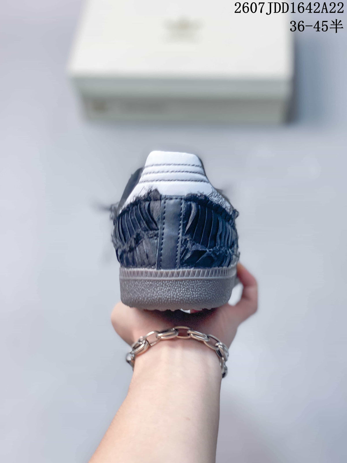 Rear view showing the textured dark heel, white heel detail, and gum-colored outsole.