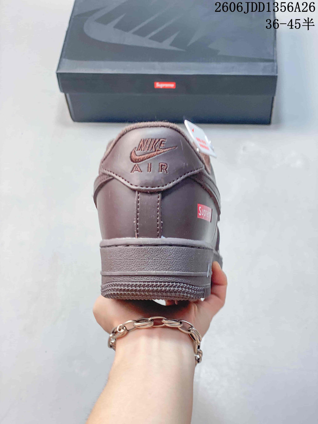 Rear view of the brown sneaker showing the heel branding and tonal sole