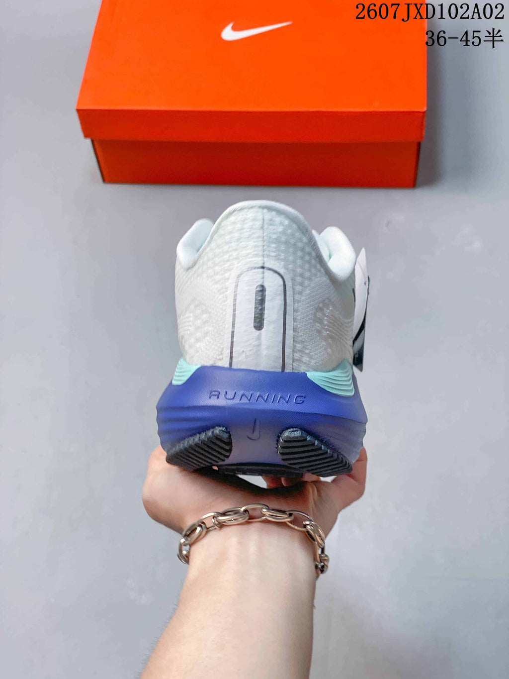Rear view of the shoe showing the heel and blue midsole