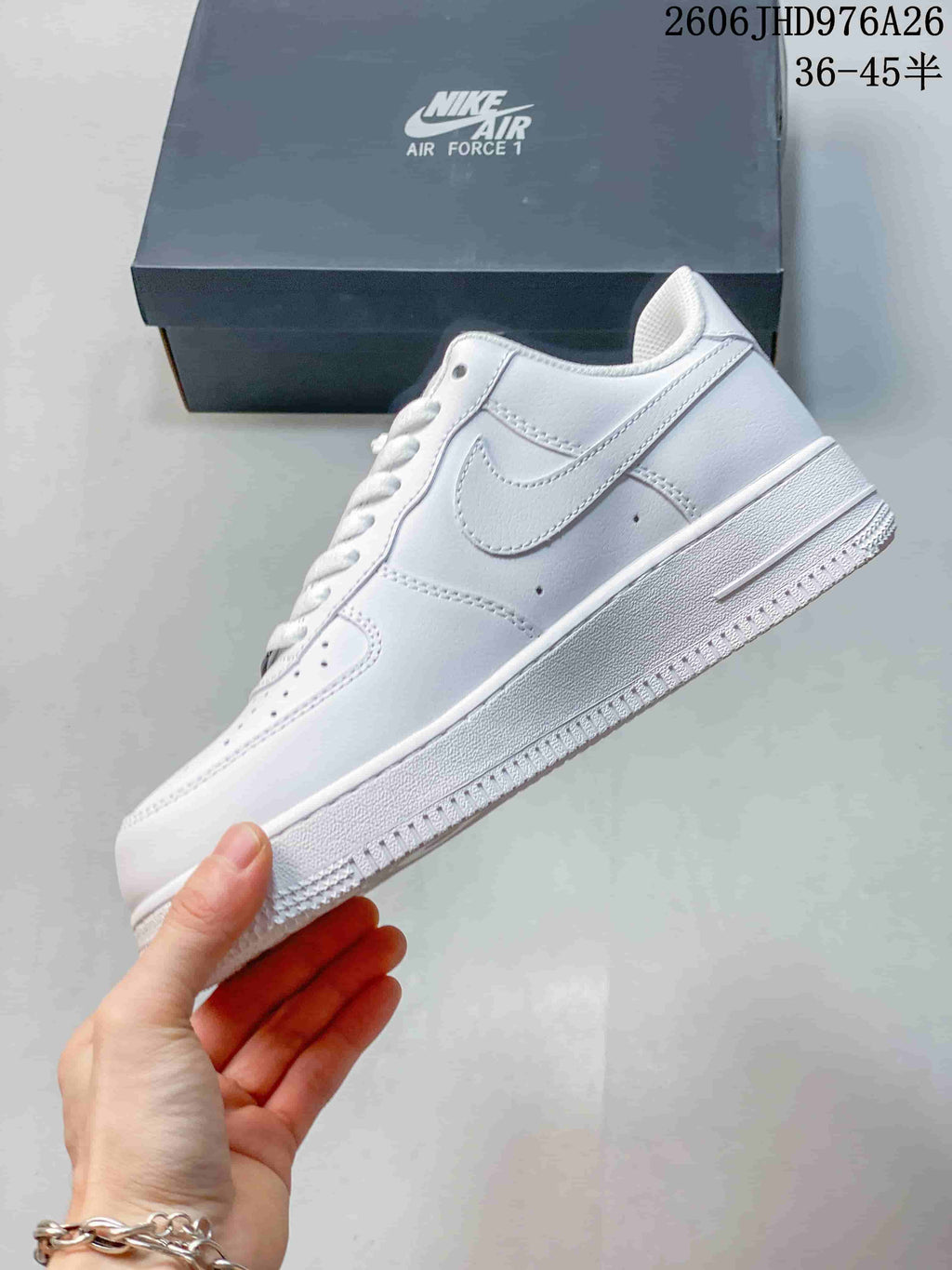 Side view of a white low-top sneaker with a white side logo.