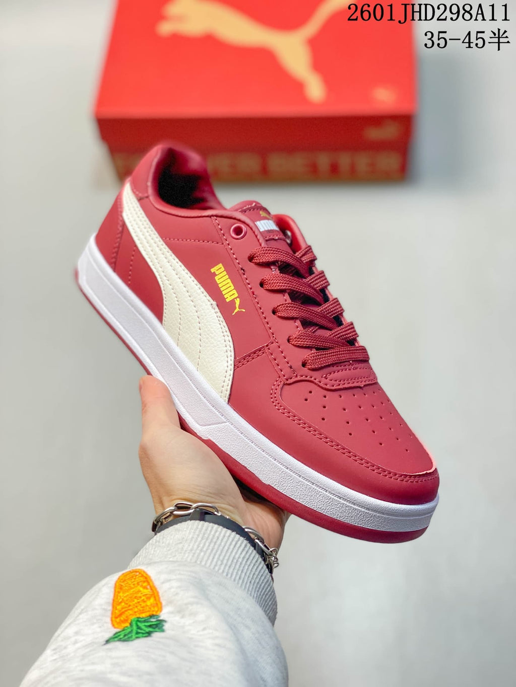 Close-up side view of a red Puma Caven 2.0 sneaker showing the contrasting side stripe, perforated toe, and lace-up design.