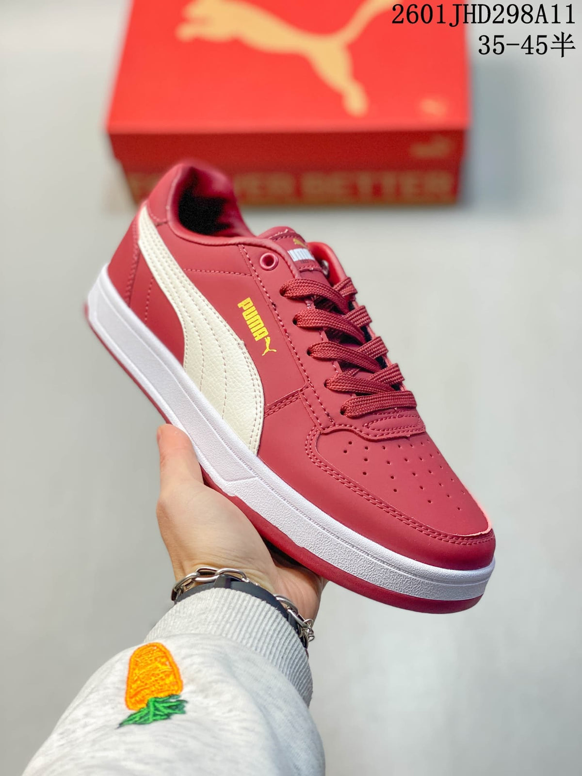 Close-up side view of a red Puma Caven 2.0 sneaker showing the contrasting side stripe, perforated toe, and lace-up design.