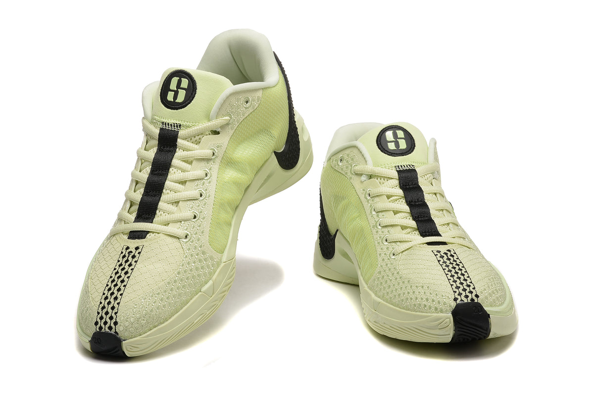 Pair of pale yellow-green and black Nike Sabrina 10 basketball shoes shown from the front