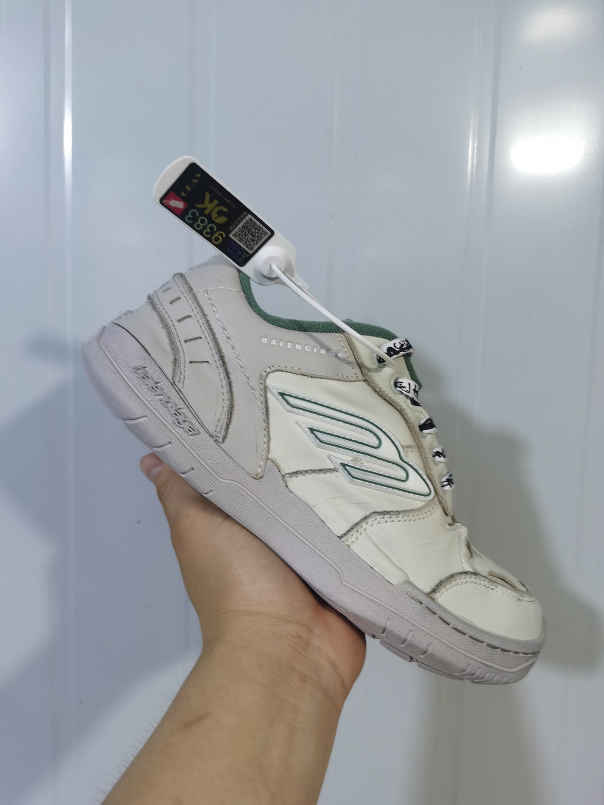 Angled view of the beige and green Balenciaga Hamptons sneaker showing the padded collar, laces, side detailing, and outsole.