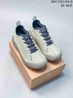 Pair of light gray and off-white NORDA low-top trail shoes displayed on a branded shoebox, with the style code and size range visible above.