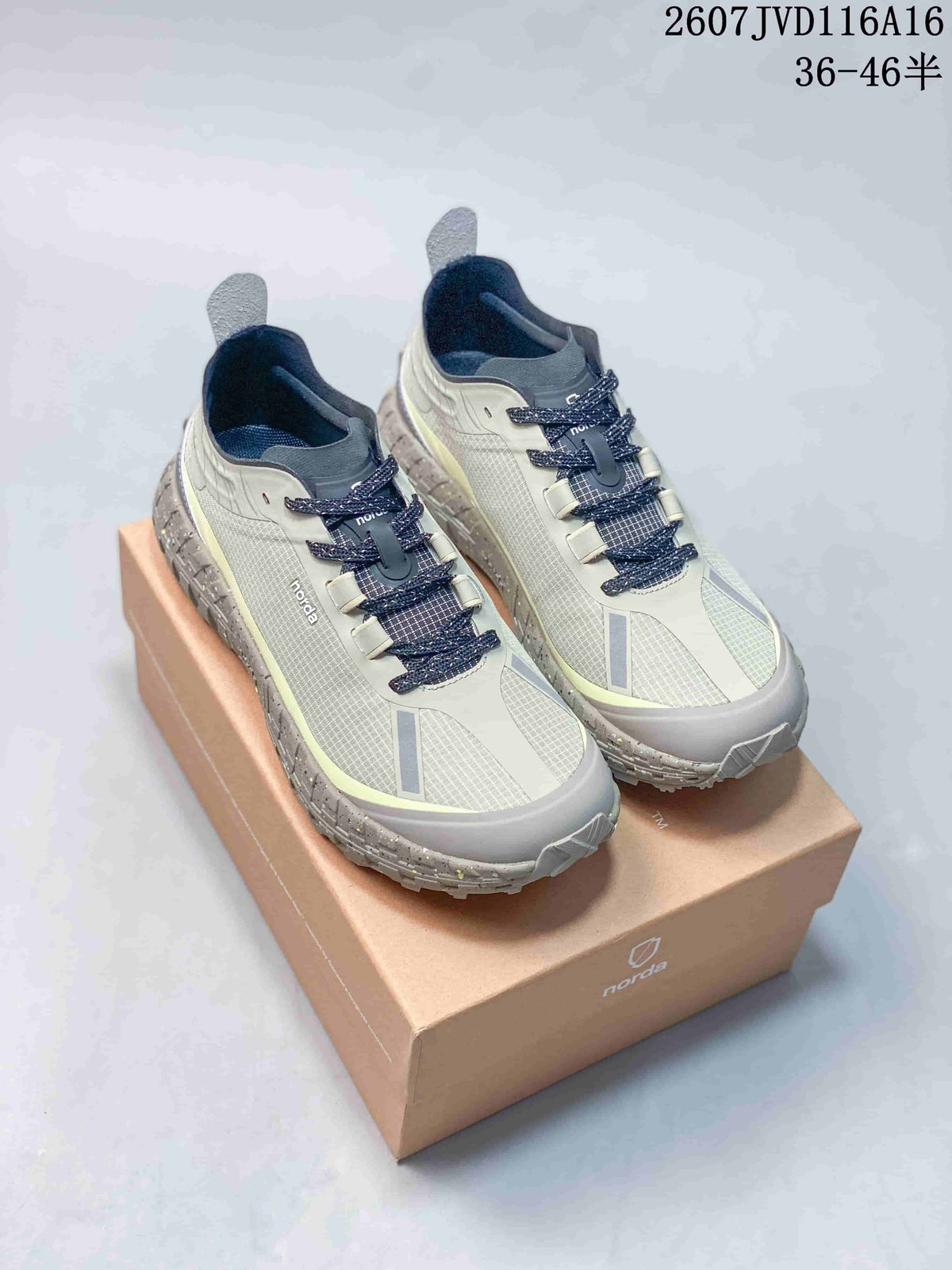 Pair of light gray and off-white NORDA low-top trail shoes displayed on a branded shoebox, with the style code and size range visible above.