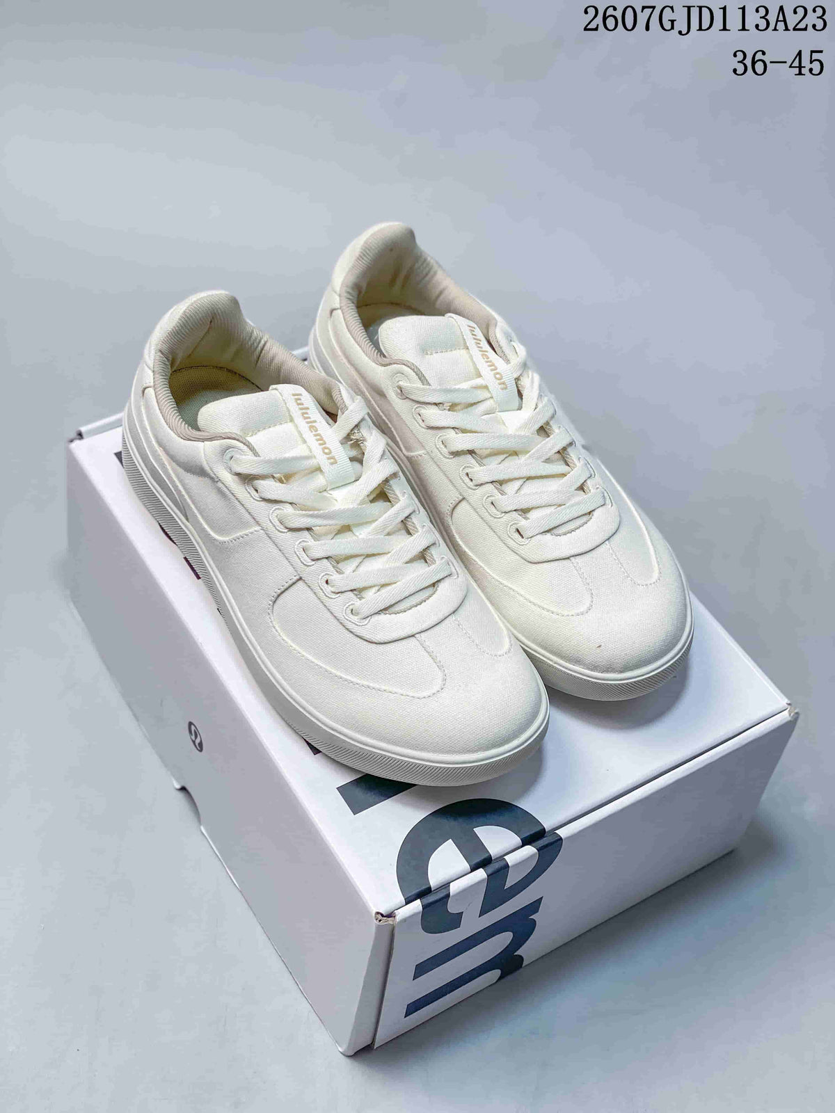 Pair of white lululemon Cityverse low-top sneakers displayed on a branded shoebox; image text shows style code 2607GJD113A23 and size range 36–45.