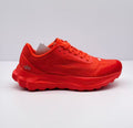 Side view of a red alo sneaker showing the textured upper, lace fastening, layered midsole, and heel logo.