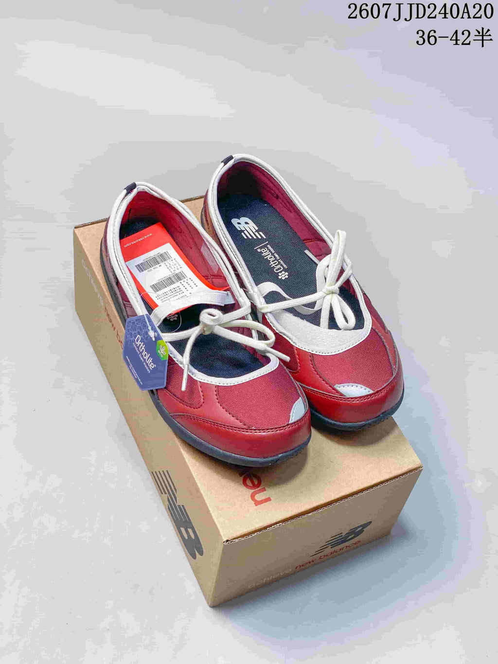 Pair of red New Balance sneakers with white detailing displayed on a branded shoe box; overlay text shows style code 2607JJD240A20 and size range 36–42.5.