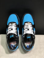Top view showing white laces, blue perforated toe boxes, black panels, and Marvel-themed insoles.