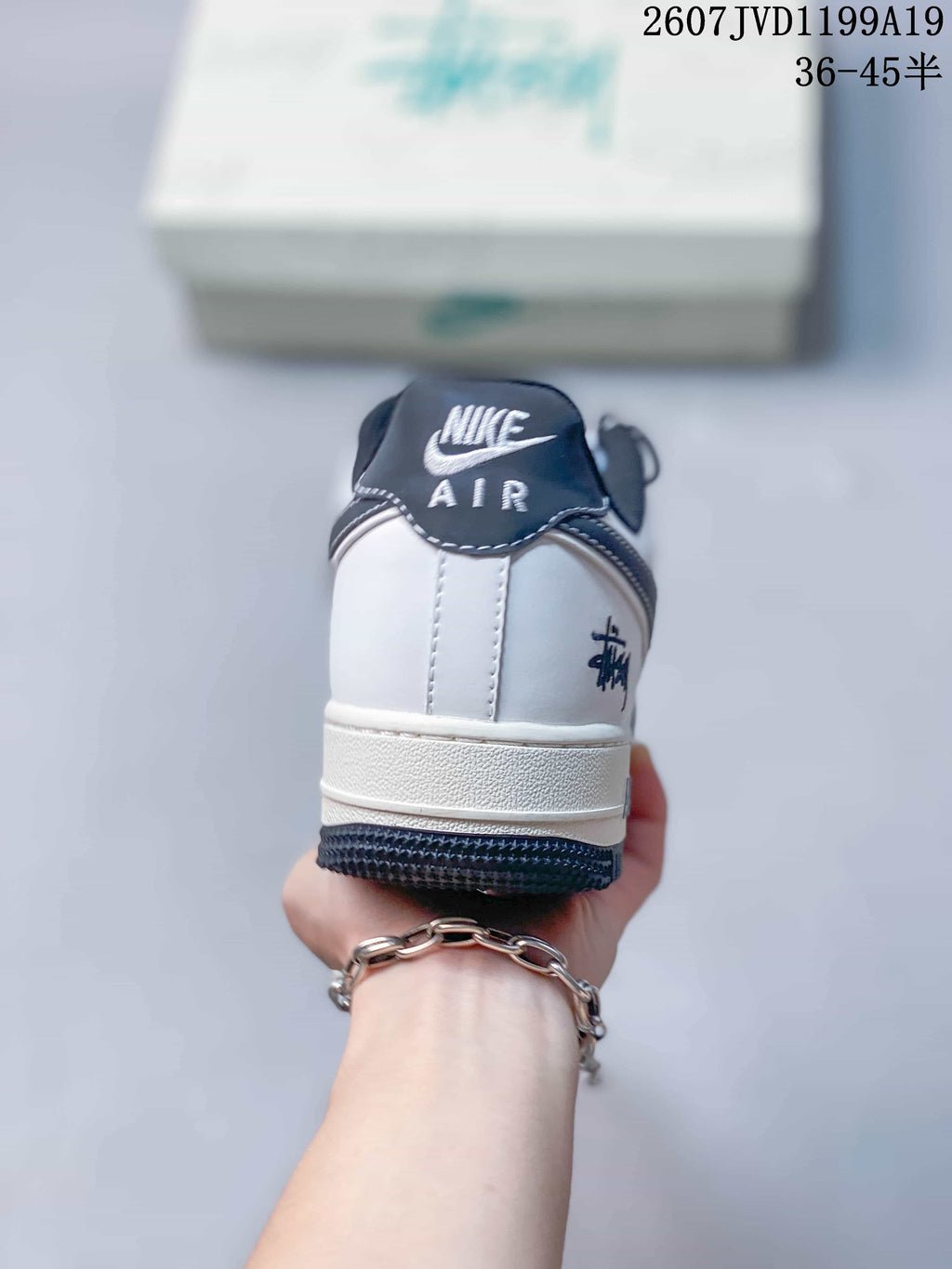 Rear view of the white sneaker showing the dark heel tab, Air branding, and contrasting outsole.