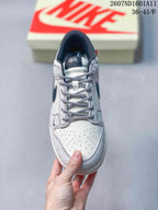 Top view of the sneaker showing patterned laces, perforated toe box, padded collar, and tongue branding.