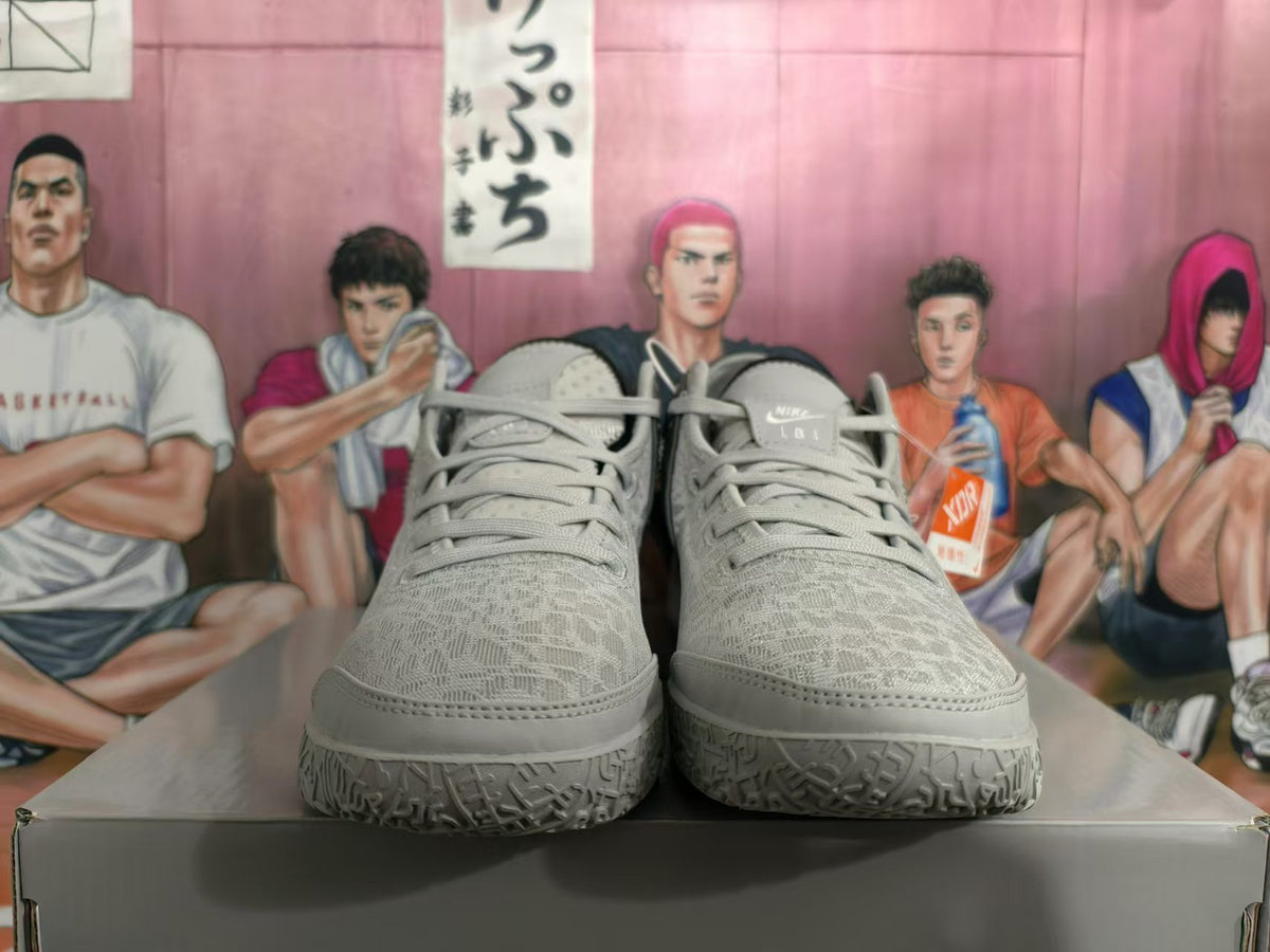 Front view showing the lace-up design and textured toe areas of silver Nike basketball shoes