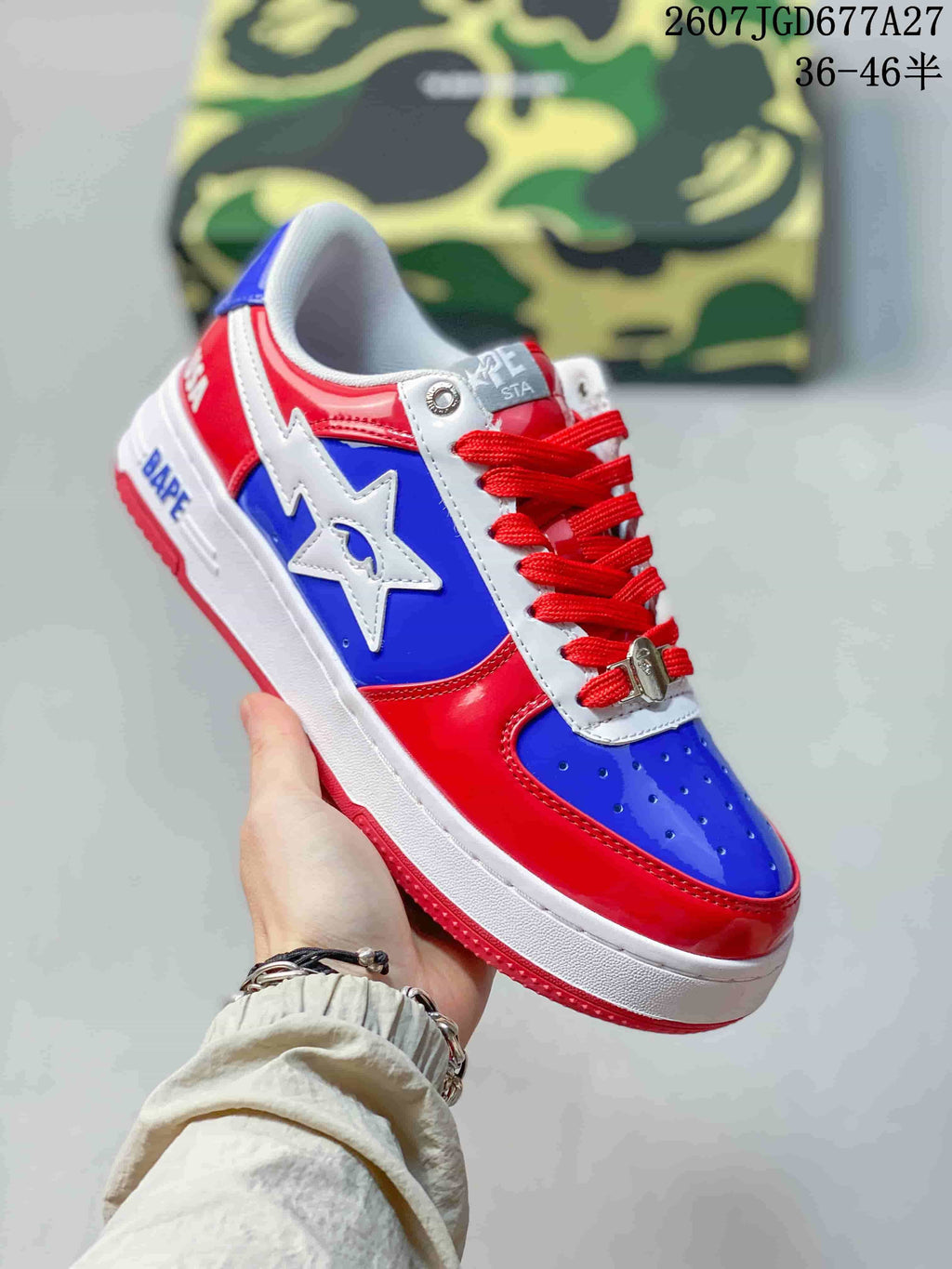 Angled side view showing the glossy red and blue upper, white star emblem, red laces, and BAPE branding on the midsole.