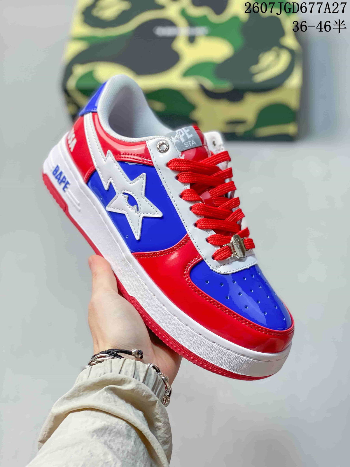 Angled side view showing the glossy red and blue upper, white star emblem, red laces, and BAPE branding on the midsole.