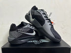 Pair of black and grey Nike Kobe basketball shoes displayed together